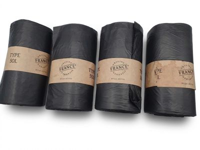 three rolls of black paper with brown labels on them