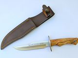 a knife and a sheath on a white surface