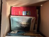 many books in a cardboard box on the floor