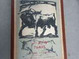 painting of a bull and a bull in a frame on a table