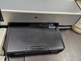 laptop and printer on a desk in an office setting