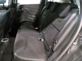 the back seats of a car with a remote control in it