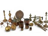 many different types of brass objects on a white surface