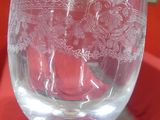 a wine glass sitting on a table in front of a red couch