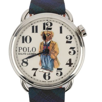 a close up of a watch with a bear on it