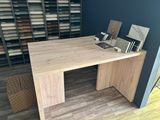 a wooden table with a book on it in a room