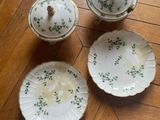 four pieces of china on a wooden floor with a wooden table