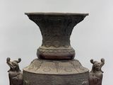 a large bronze vase with two elephants on it