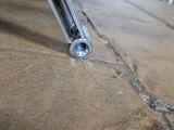 a close up view of a screw and bolt on the floor