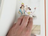 a hand that is holding a book with a picture of a woman on it