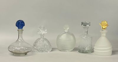 five glass vases sitting on a table with a white background