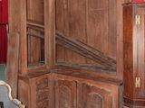 a large wooden cabinet in the corner of a living room