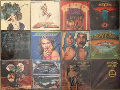 many different album covers on the wall of a room