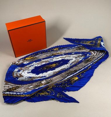 an orange box and a blue scarf on a white surface