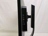 a close up of a computer monitor on a stand on a white surface