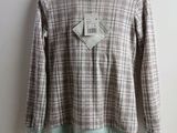a close up of a shirt on a hanger on a wall