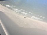 a close up of a car ' s door handle with a sticker on it