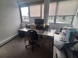 a desk with a computer and a laptop on it