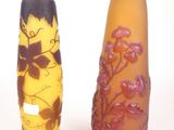 two vases sitting next to each other on a white surface