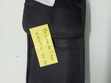 a black case with a yellow sticker on it sitting on a table