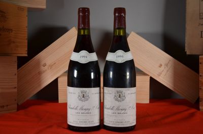 two bottles of wine sitting next to each other on a table