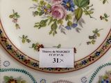 a plate with a floral design on it sitting on a table