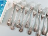 a lot of silver forks and spoons on the table