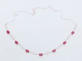 a necklace with pink stones on a white background