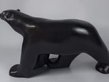 sculpture of a black polar bear on a white background