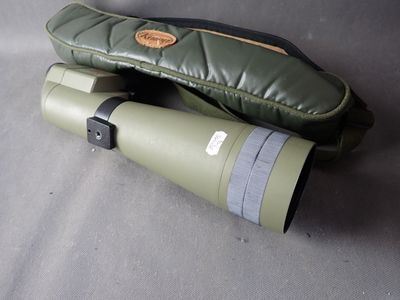 a pair of binoculars sitting on a table next to a pair of mittens
