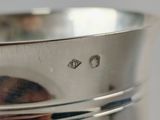 a close up of a silver cup on a table