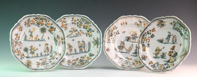 three plates with different designs on them sitting next to each other