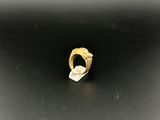 a close up of a gold ring on a black surface