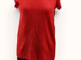 the top of a woman ' s red sweater on a mannequin dummy
