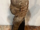 a close up of a statue of a woman ' s head on a black base