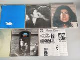 a lot of records on the wall with pictures on them