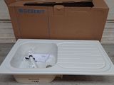 a white sink sitting next to a cardboard box on the ground