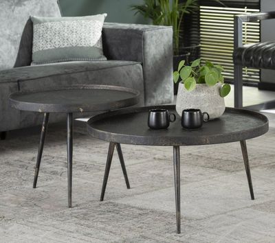 the two tables are sitting on the rug in the living room