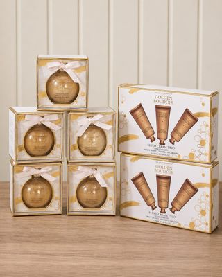a set of six gold christmas ornaments sitting on top of a wooden table