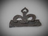 a small metal object with a fleur on it