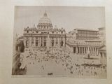 an old picture of a large building with a lot of people around it