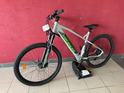 mountain bike in front of a red wall in a room