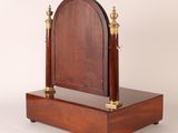 an image of a wooden and brass clock on a stand