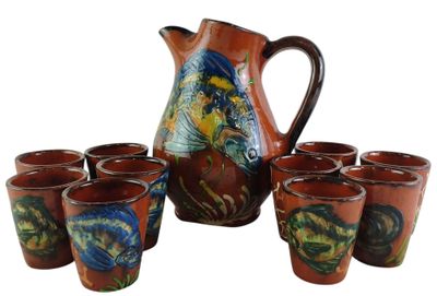 six cups and a pitcher sitting next to each other