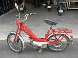 a red bike that is parked in a garage