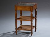 a small wooden table with a marble top on it