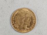 a close up of a gold coin on a white surface