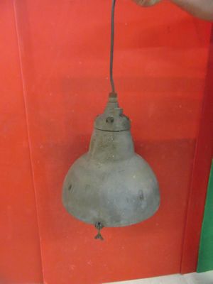 a person holding a light that is attached to a wall