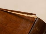 a close up view of a wooden chair with a wood seat