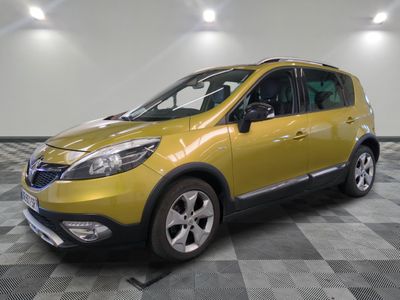 the yellow car is parked in the garage on a checkered floor